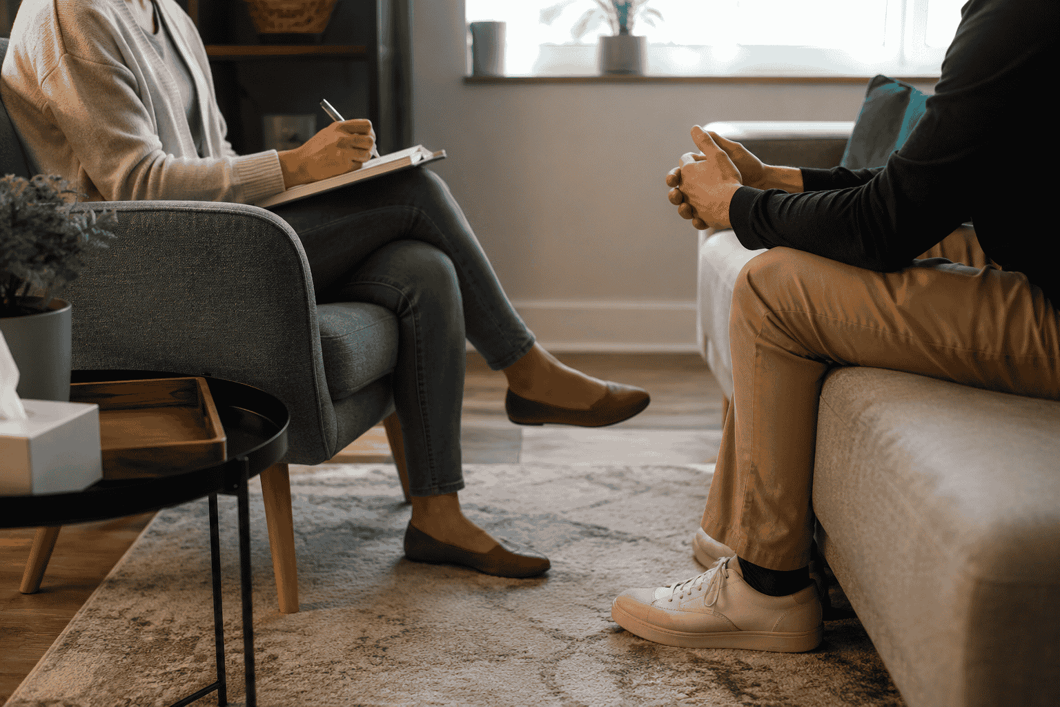 Substance abuse counselor and client having a private therapy session in a comfortable counseling office